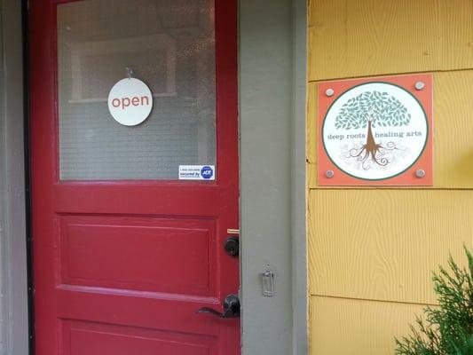 Front door with the 'Deep Roots Healing Arts' sign....