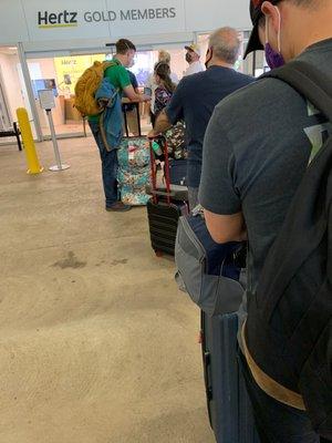 The line of people waiting to rent a car at Hertz and only one clerk.