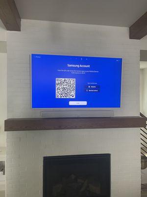 Samsung Frame mounted above brick fireplace. Sonos Arc mounted below. Power Concealed