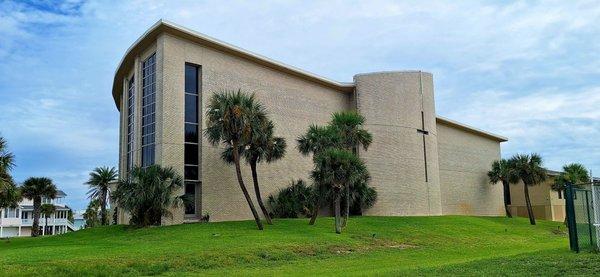 This is a side view of this Catholic parish church in Pensacola Beach FL as seen from the adjacent tennis courts' parking lot (no review)