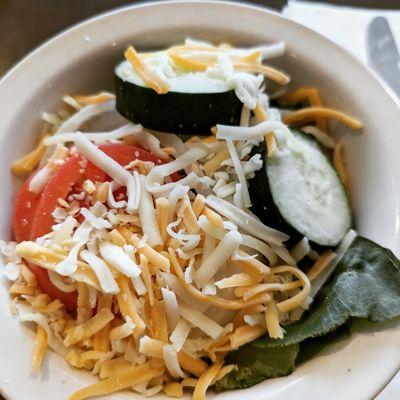 Salad with lettuce, cheese, tomatoes, cucumber and onion