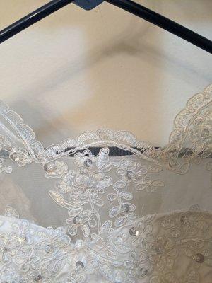 Destroyed wedding gown! Lace set too high on the throat. Now the entire piece is off center by a full inch!