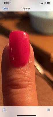 Crooked top of nail and no acrylic in right corner of nail