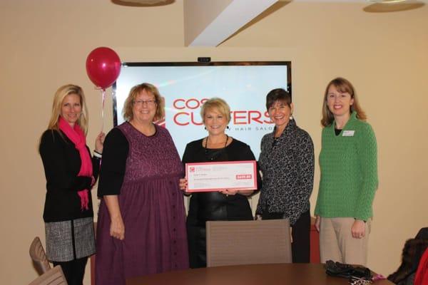 Presenting a check to staff at Susan G Komen in October of 2014.  10 cents for every haircut we did in the month.