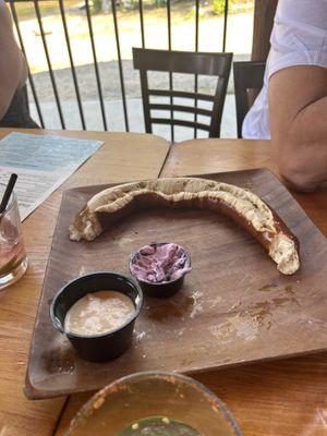 Pretzel with cheese and a delicious huckleberry dip