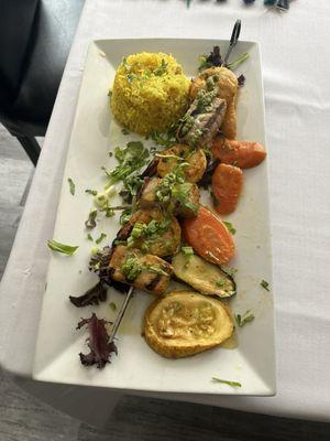 Grilled salmon and prawn kebab skewer, with saffron rice and medley of vegetables.