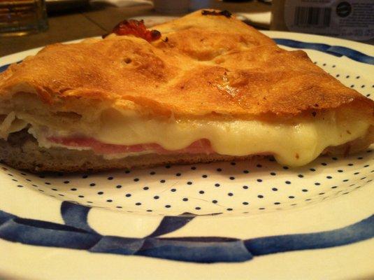 Ham, cheese, ricotta calzone halved