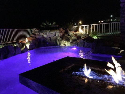 Fire pit on patio and fire coming out of both sides of the waterfall.  Never gets old looking at it!