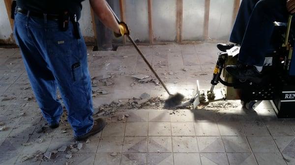 Beginning removal of a floor that's two layers of ceramic tile.