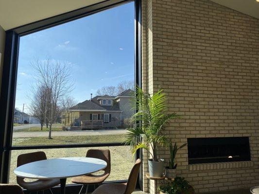 Large windows and fireplace in seating area