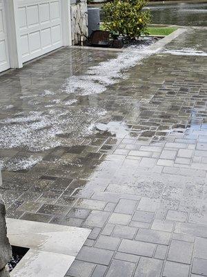 Hail and rain on paver driveway which kept water out of garage with drains that worked.