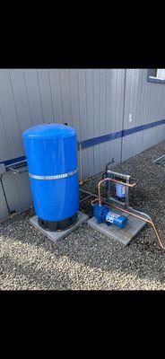 New booster pump installation with bladder tank servicing a trailer restroom.