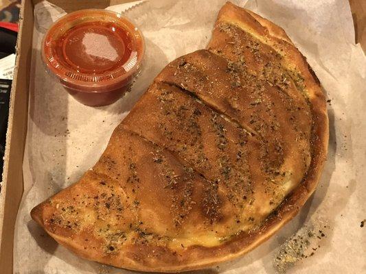 Supreme calzone with marinara sauce