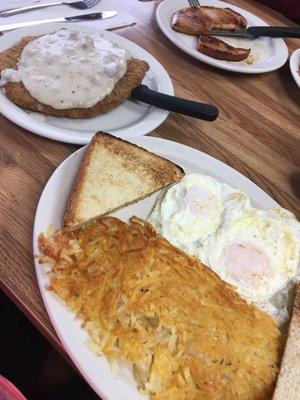 Chicken fried steak with sausage gravy, eggs, hash browns and toast. Excellent!