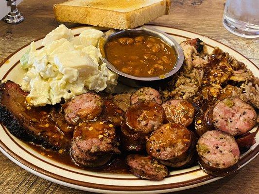 Sampler plate. Brisket, pulled pork and sausage. Potato salad was good but I really don't like the beans