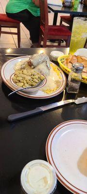 Baked chicken served with rice, lima beans, and house made chips,