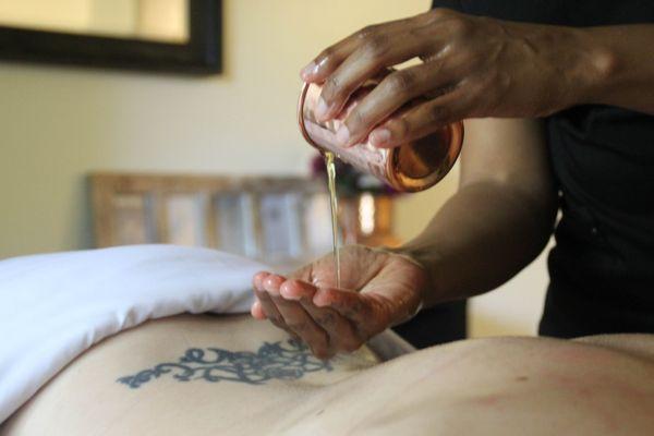 Generous amounts of pure, organic warm oil applied by Tesia Love, our highly-trained and experienced Ayurvedic therapist.