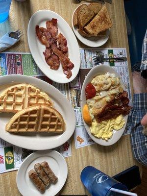 Our breakfast! Waffles. Bacon. Oatmeal toast. Eggs. Hash browns.