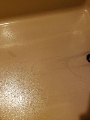 Cracked tub floor in old bathroom. "Bella Vista"