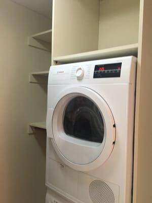 Stacked  high efficiency w/d in unit with timer to do your wash when you're at work--very cool!