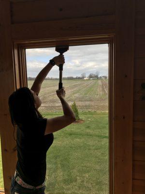 Jordan installing some home window tint with a Fusion Stretch Squeegee Handle and a Fusion Hybrid Squeegee blade.