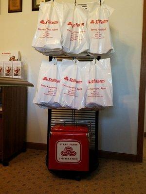 Customer "goodie bags" and a cool retro State Farm metal cooler.