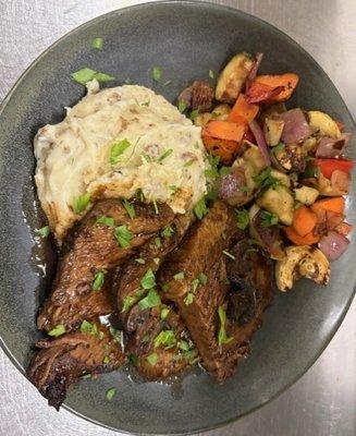 House Smoked Brisket served with mashed potatoes and seasonal Vegetables