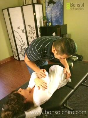 Dr. Jeremy adjusting a patient's low back and hips.  Ankle and knee pain may be caused by imbalance in the pelvic and lumbar joints.