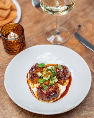 Moroccan Meatballs with spiced BBQ glaze, whipped feta, 
 cucumbers, gremolata