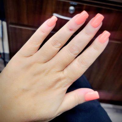 Lovely bright coral color on Acrylic nails