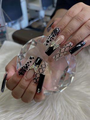 Long Acrylic Nails with Hearts Design and Butterfly Charms and Diamonds