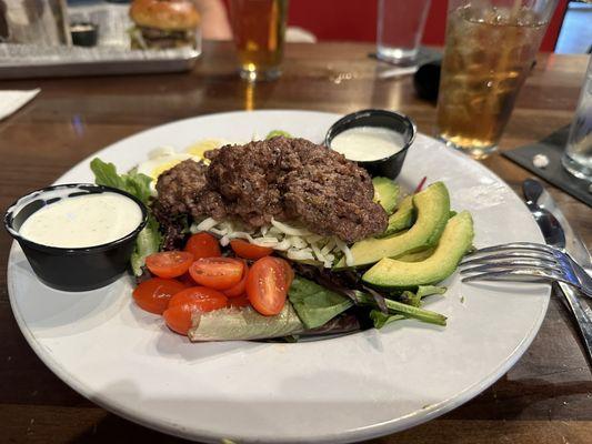 Cobb salad with hamburger and ranch dressing.