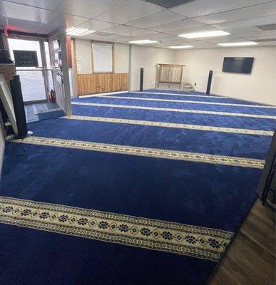 Men's prayer hall with newly added carpets and additional space provided. With a wudhu facility and restroom.