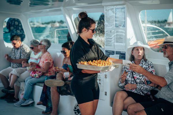 Crew member passing out appetizers