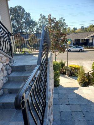 Metal railing with belly pickets, powder coated.