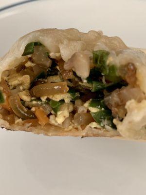 13. Pan fried juicy bun filled with veggies, noodles, mushrooms and egg.