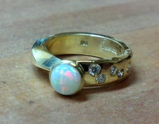 18kt. gold asymetric ring bezel set with opal, flush set diamonds.