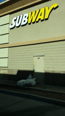 I am actually at the KFC behind this subway and there is all this trash piled by the door.  It smells horrible!