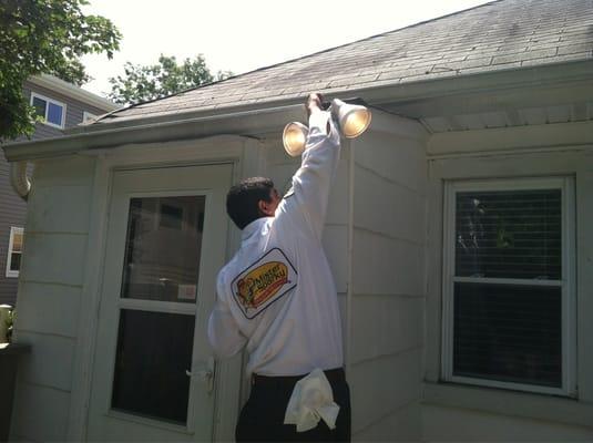 Electrician installing a new security light.