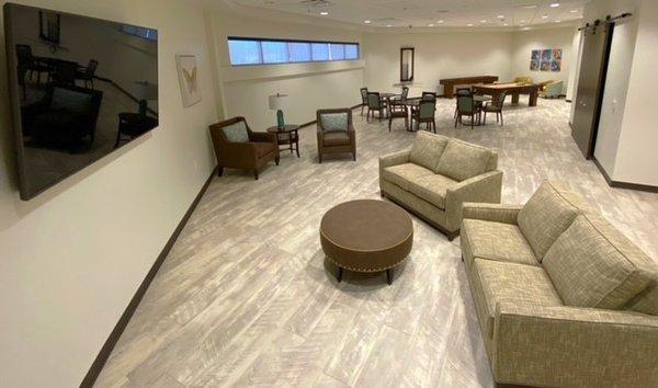 Day Room: lounge area for resident's with couches, comfy chairs, a big TV, tables with chairs to play games, pool table, and shuffleboard.