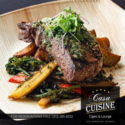 New York Strip 10 oz. USDA-certified Prime beef steak, red skin steamed potatoes, broccolini and rainbow carrots served with homemade basil