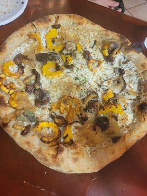 Mushroom pizza with delicata squash, caramelized onions, sage, tolman and mozzarella cheese