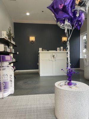 Front desk/ a wall of products they sell. It was Botox day, so they had cute decorations and free cookies!