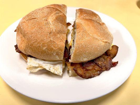 Bacon, egg, and cheese sandwich. Two eggs. Comes with one cup of coffee. $5.25 + tax + tip