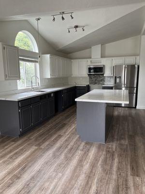 Finished new island and quartz countertops and cabinets painted. Beautiful,