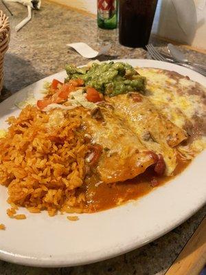 Two chicken enchiladas with rice and refried beans