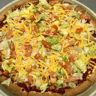 Taco Pizza | Taco Meat Base | Lettuce | Tomato | Cheddar Cheese | Served w/ Taco Sauce