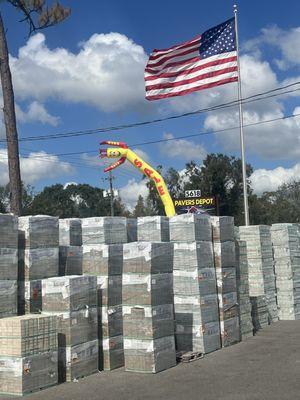 Pavers Depot's sign with towers of pavers always in stock.