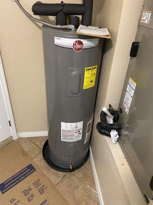 A typical Waterheater installation. Note the pan beneath to isolate the heater from the floor.