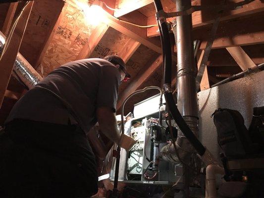 James inspecting the Carrier AC unit in the attic